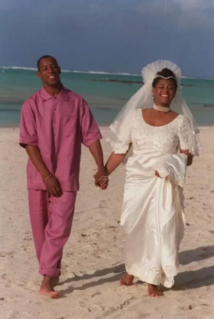 Ian Wright and his first wife, Deborah Martin, holding hands on a beach in Mauritius during their 1993 wedding ceremony. A historical record of Wright's first marriage.